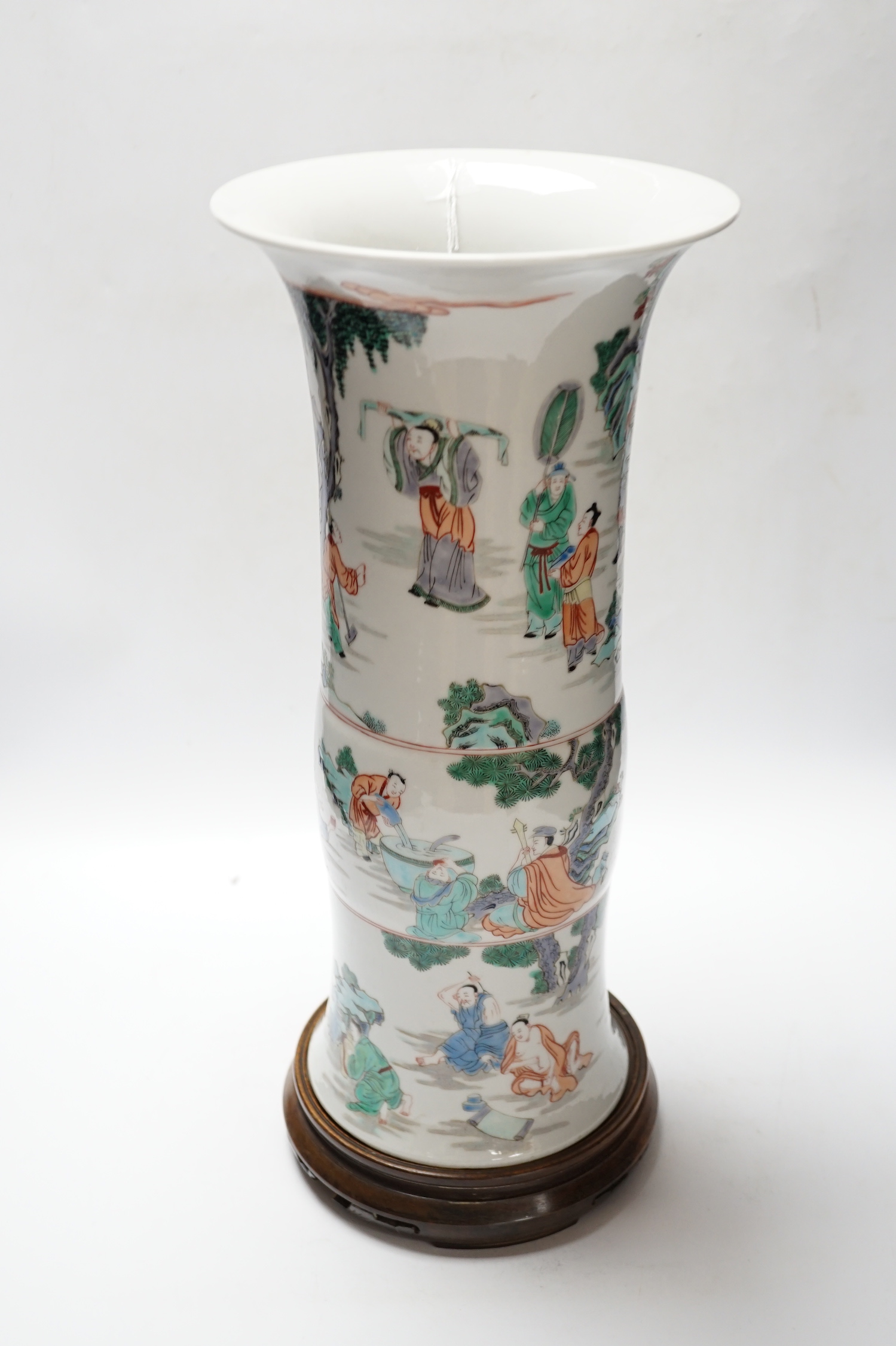 A Chinese famille verte beaker vase, Kangxi mark but later, on hardwood stand, 46cm total height